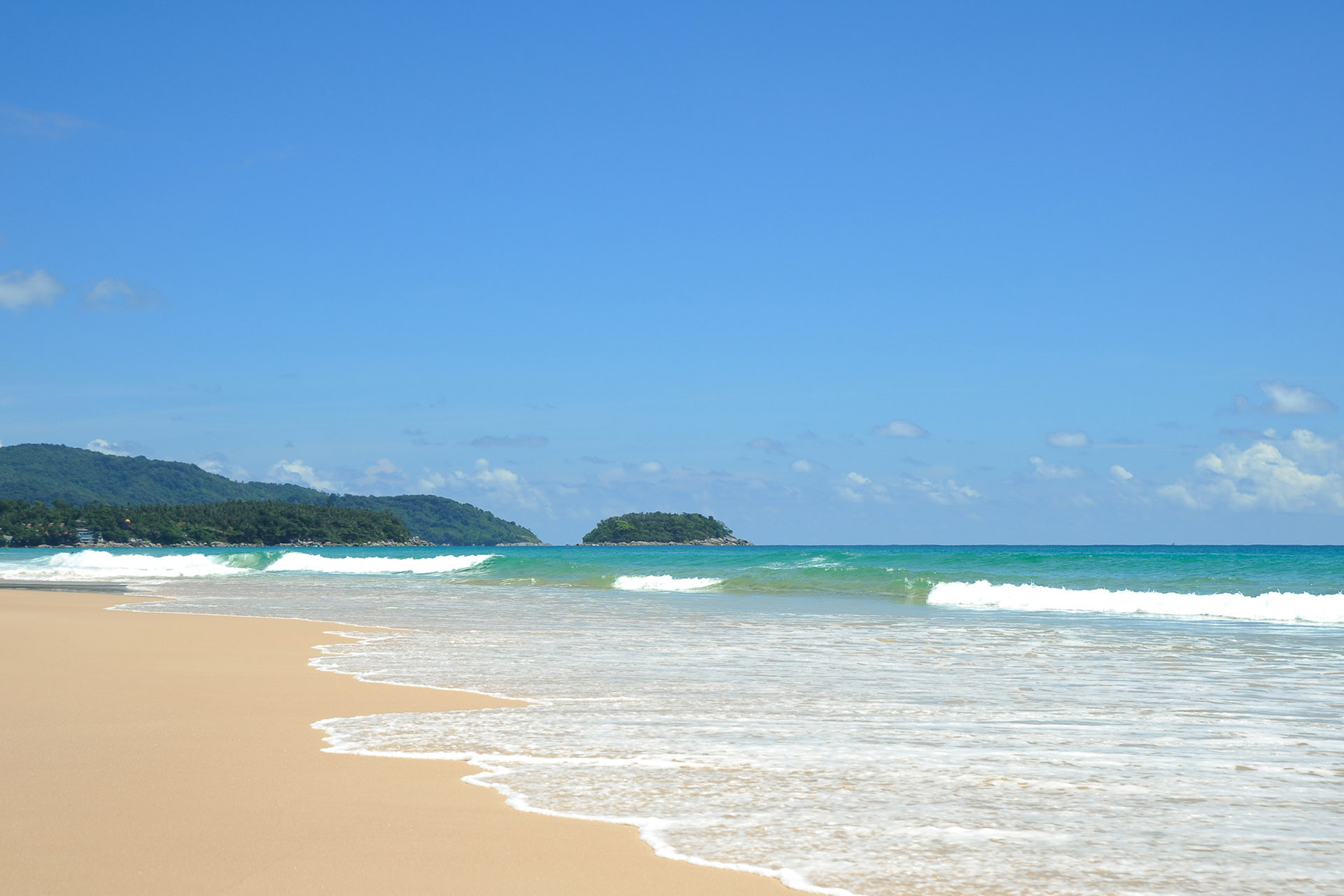 Karon Beach on a sunny day with the view of Poo island